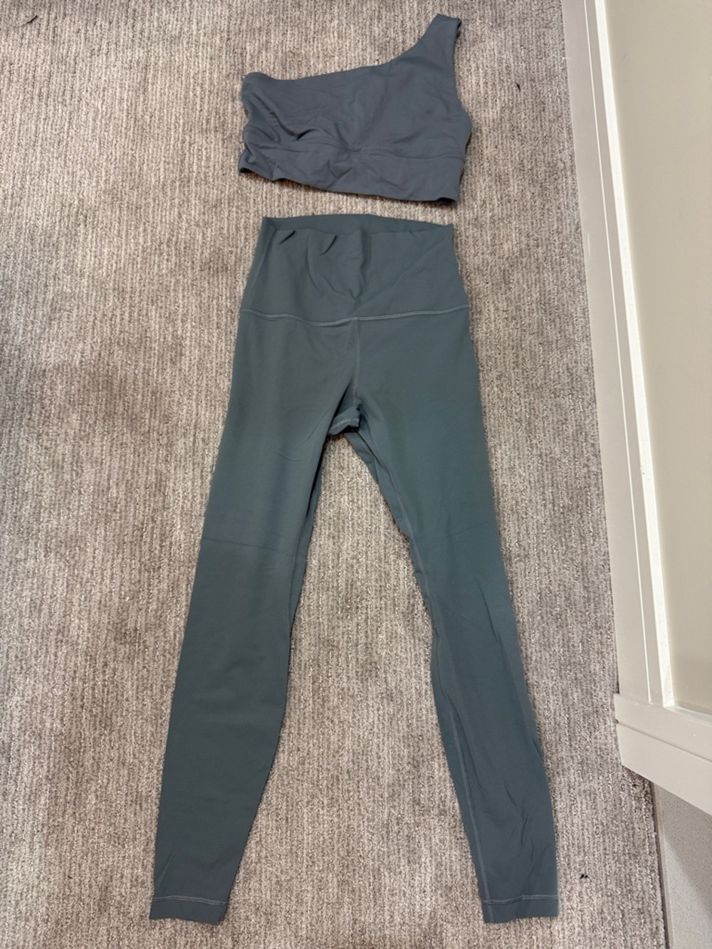 Lululemon Shoulder Sports Bra and High-Waist Leggings Set in blue/grey color.